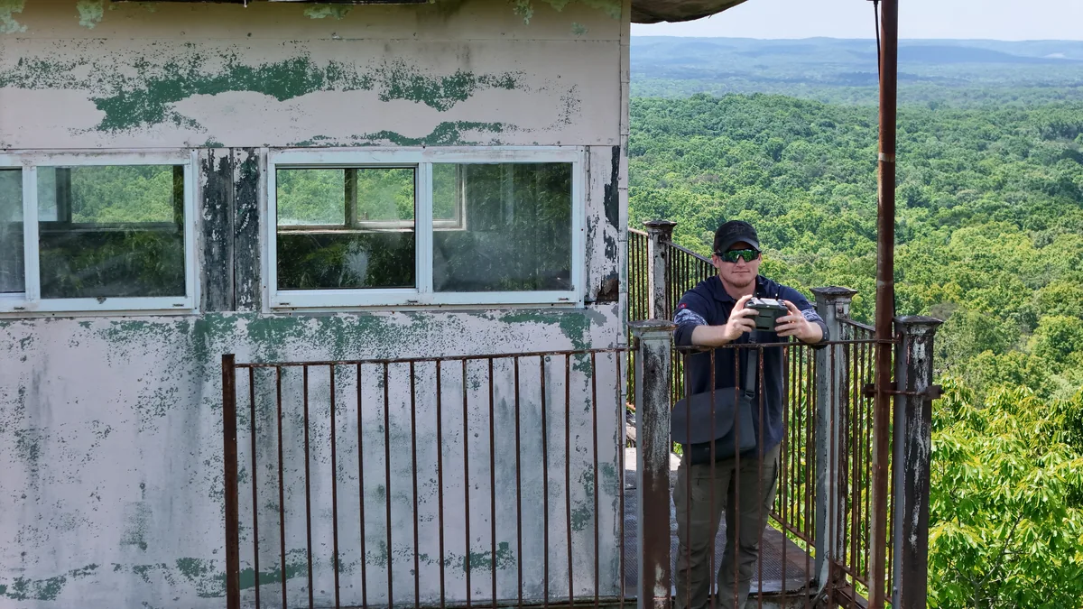 Owner Rory Johnson, FAA Part 107 certified drone pilot, operating a drone in the field