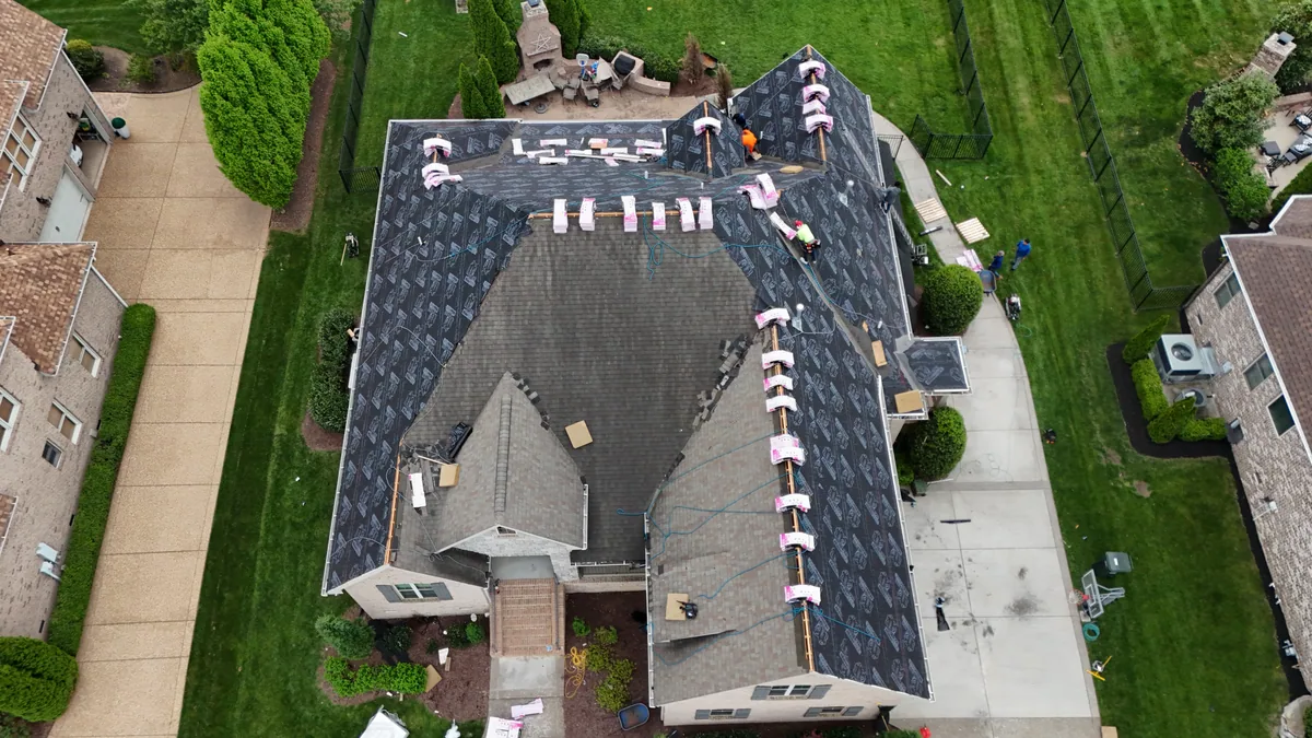 Roof work underway with materials staged on a Brentwood, TN home, April 14, 2026