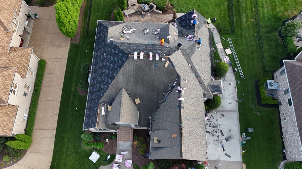 Roof work underway with materials staged on a Brentwood, TN home, April 14, 2026