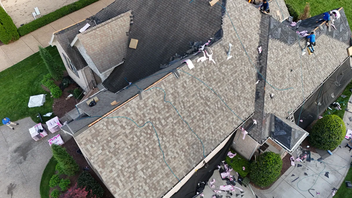 Roof work underway with materials staged on a Brentwood, TN home, April 14, 2026