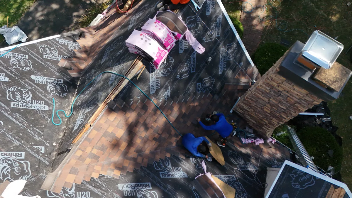 Roofers installing underlayment across a McMinnville, TN roof