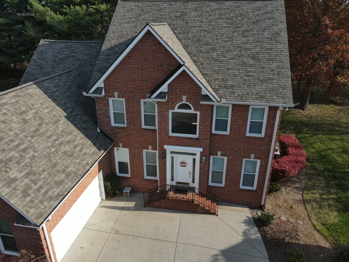 Front elevation of a brick Murfreesboro, TN home during a drone roof inspection