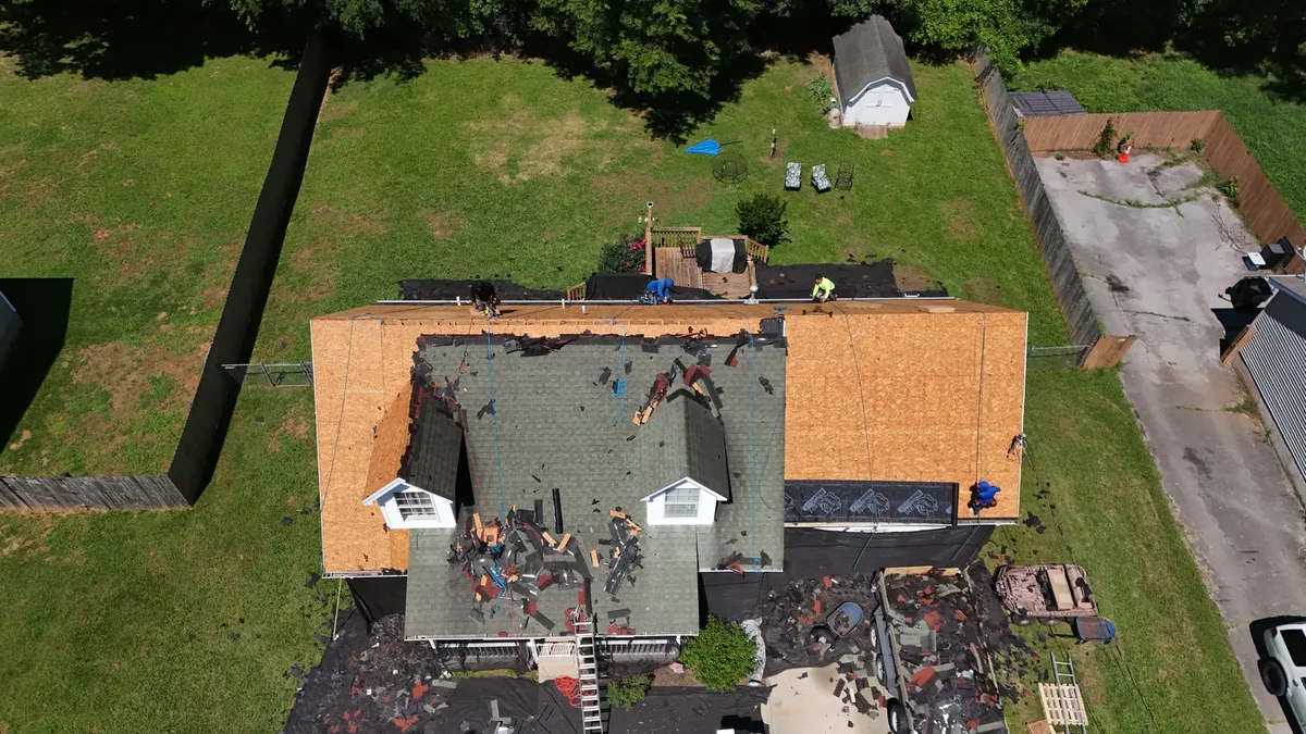 Roof tear-off in progress on a Murfreesboro, TN home, old shingles removed to the decking
