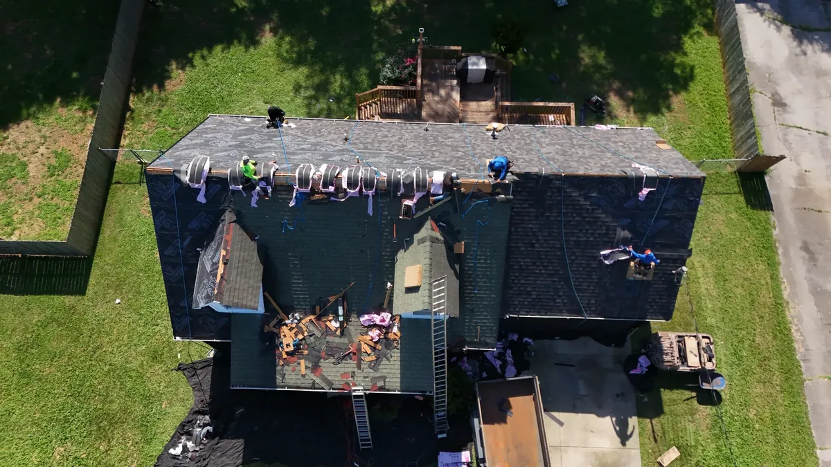 New architectural shingles being installed during a roof replacement in Murfreesboro, TN