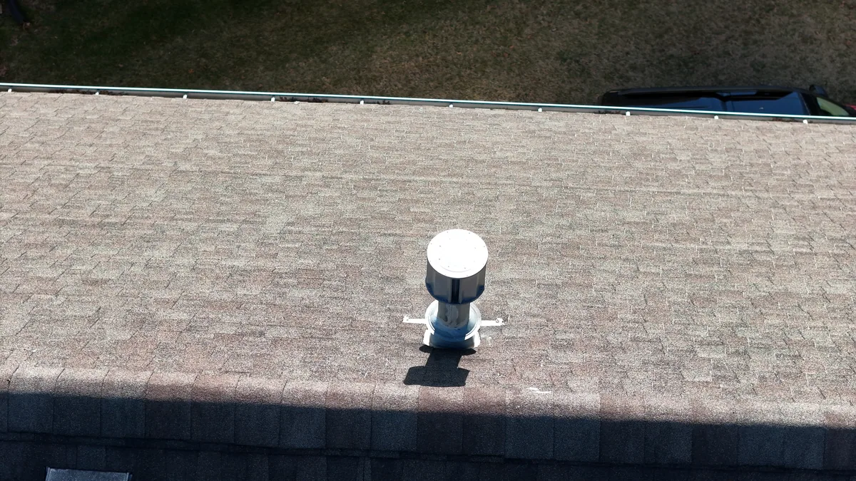Close drone view of a ridge line and roof vent on a Nashville, TN home during an inspection