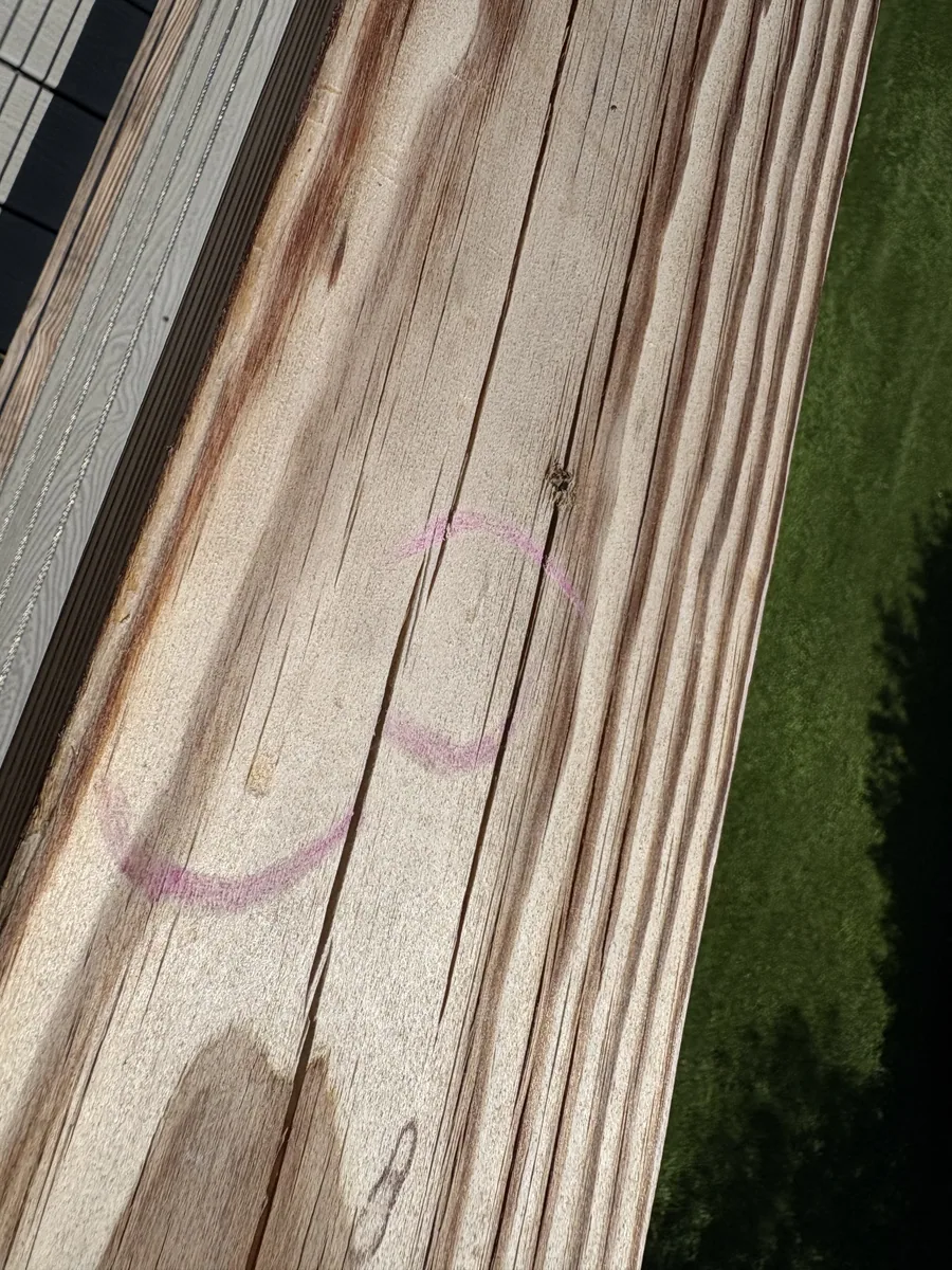 Water-stained wood decking close-up documented during a roof claim