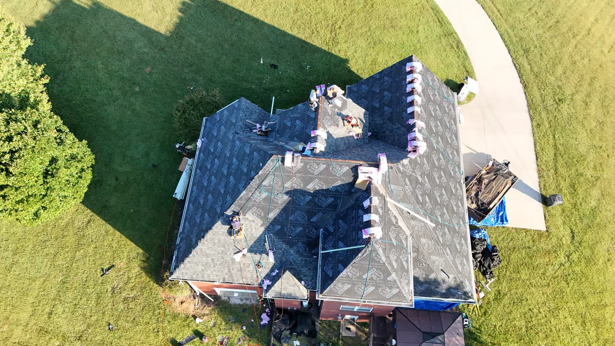 Crew and staged shingles on a large Bedford County, TN roof during replacement