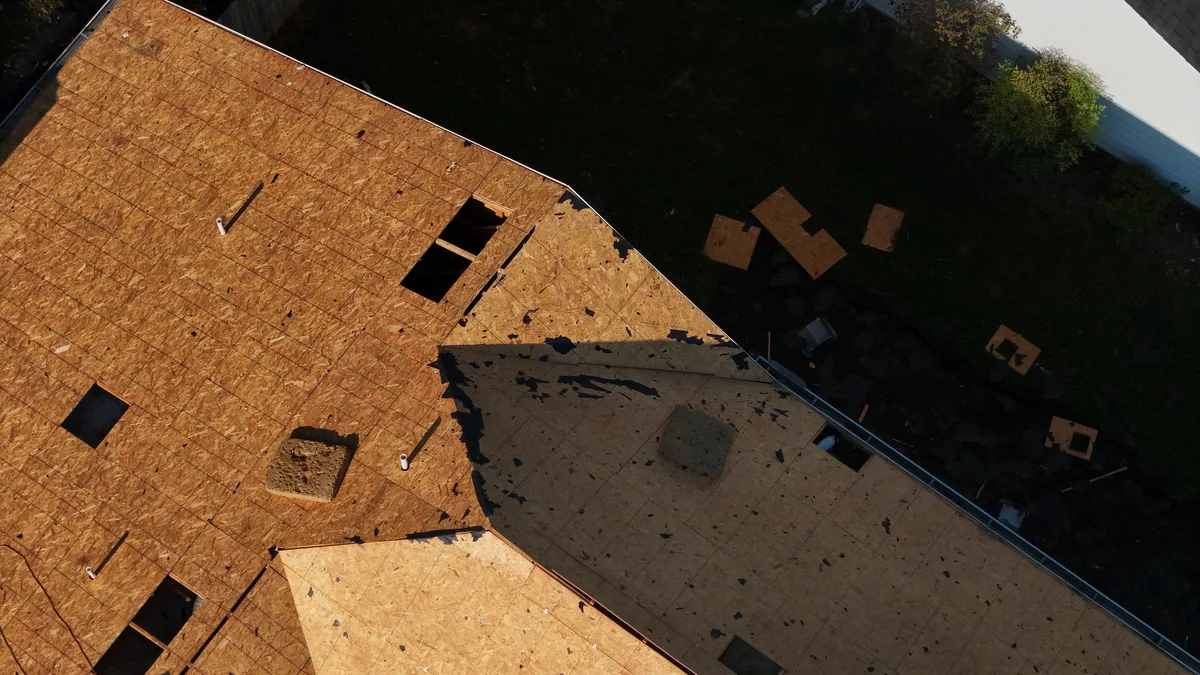 Close view of exposed roof decking with new plywood patches during a Smyrna, TN roof replacement